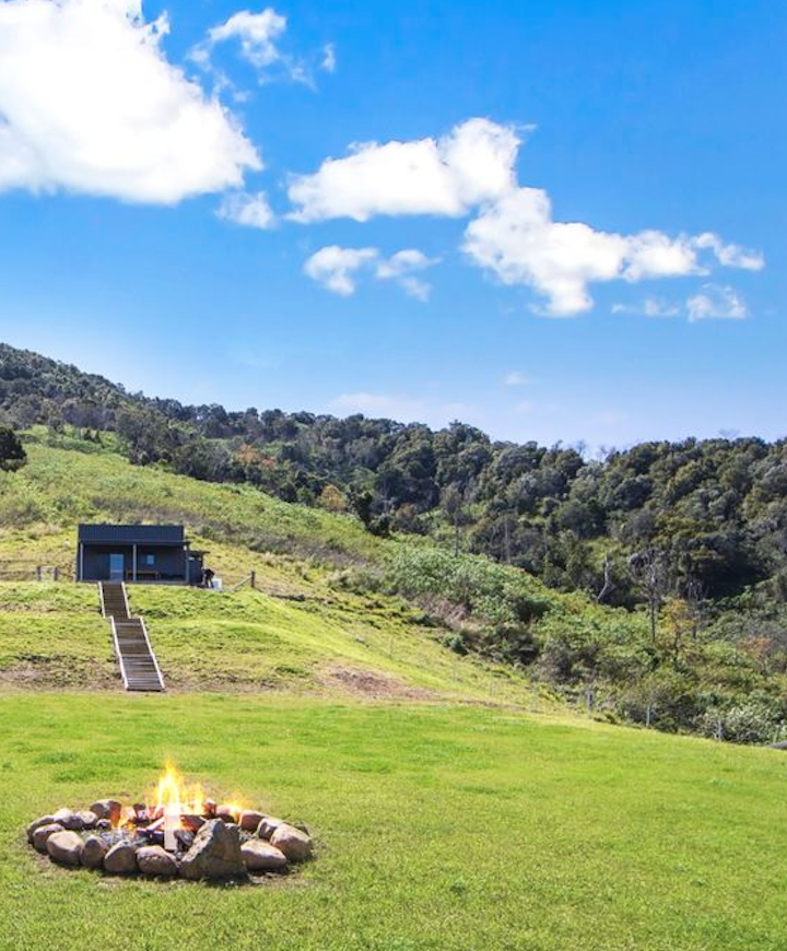 The Sunset Shanty tiny house overlooking the firepit and green hillside